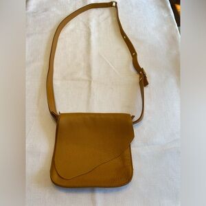 Mustard yellow pebbled leather crossbody bag.
